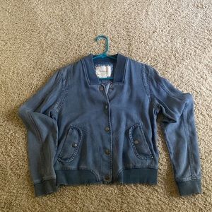 Anthropologie lightweight denim jacket with snaps in the front.